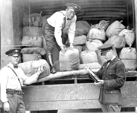 Upper Darby Police inspect about $72,000 in liquor seized during a raid. 1930